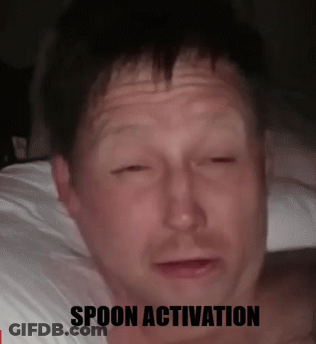 A Man Laying On A Bed With His Eyes Closed And The Words Spoon Activation Below Him GIF