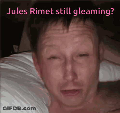 A Man Laying On A Bed With The Words Jules Rimet Still Gleaming GIF