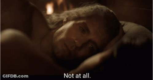 A Man Laying On A Bed With The Words " Not At All " Next To Him GIF
