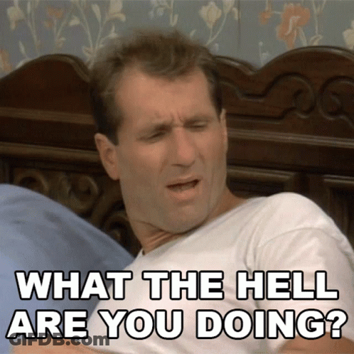 A Man Laying On A Bed With The Words What The Hell Are You Doing Behind Him GIF
