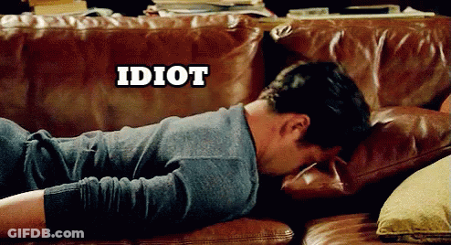 A Man Laying On A Brown Leather Couch With The Word Idiot Above Him GIF