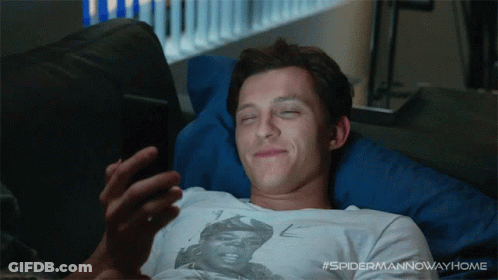 A Man Laying On A Couch With His Eyes Closed Looking At His Phone With The Hashtag #Spidermannowwayhome GIF