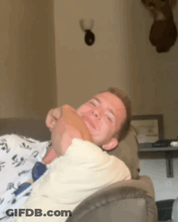 A Man Laying On A Couch With His Head On Another Person 'S Lap GIF