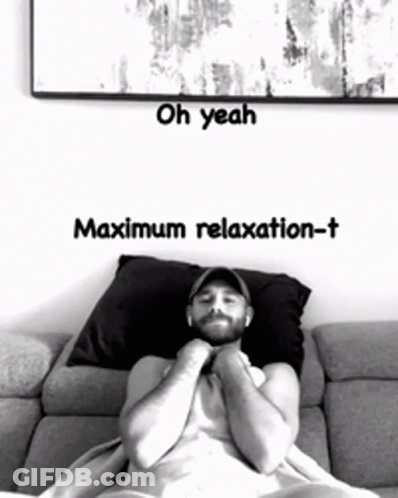 A Man Laying On A Couch With The Words Oh Yeah Maximum Relaxation-T On The Bottom GIF