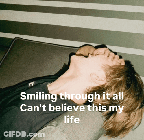 A Man Laying On A Couch With The Words Smiling Through It All Can 'T Believe This My Life Above Him GIF