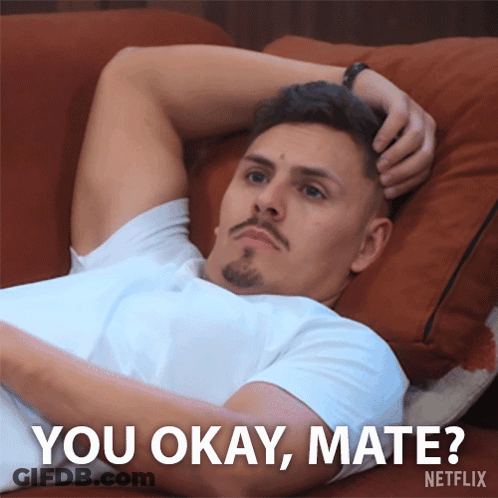 A Man Laying On A Couch With The Words " You Okay Mate " Written Below Him GIF