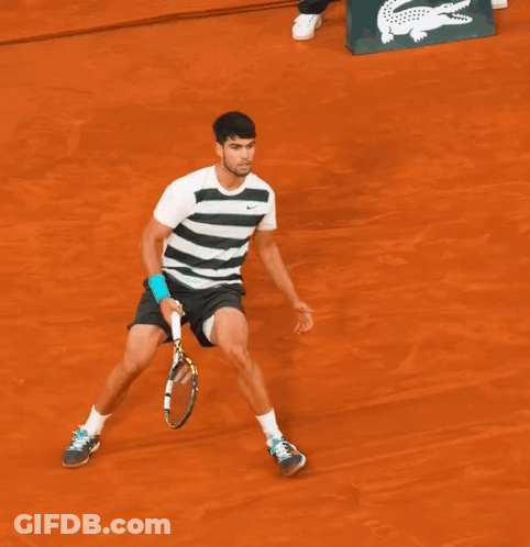 A Man Laying On A Tennis Court With A Babolat Tennis Racquet Next To Him GIF