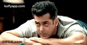 A Man Laying On His Stomach With His Head Resting On His Hands With The Website Kulfyapp.com In The Corner GIF