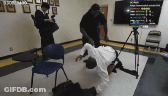 A Man Laying On The Floor In Front Of A Tv With The Number 3303/3400 On It GIF