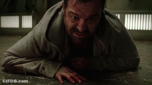 A Man Laying On The Floor With Blood On His Face And Hands GIF