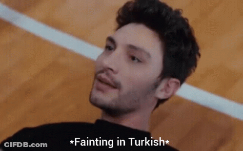A Man Laying On The Floor With The Words Fainting In Turkish Above Him GIF
