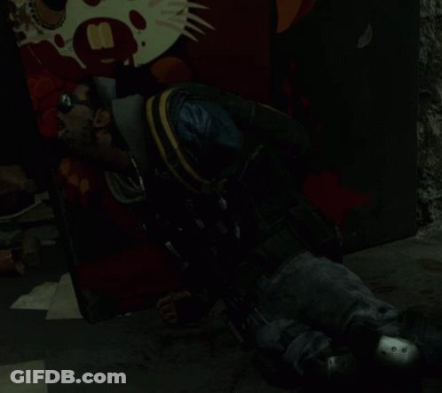 A Man Laying On The Ground In Front Of A Wall With A Picture Of A Cat And The Number 8 On It GIF
