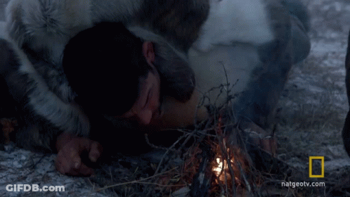 A Man Laying On The Ground With A National Geographic Logo In The Background GIF