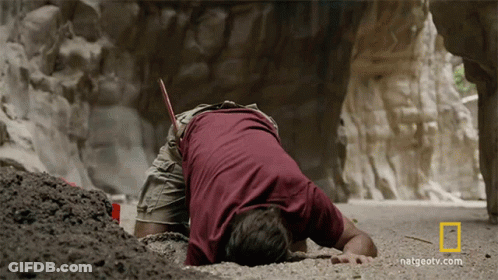 A Man Laying On The Ground With A National Geographic Logo On The Bottom GIF