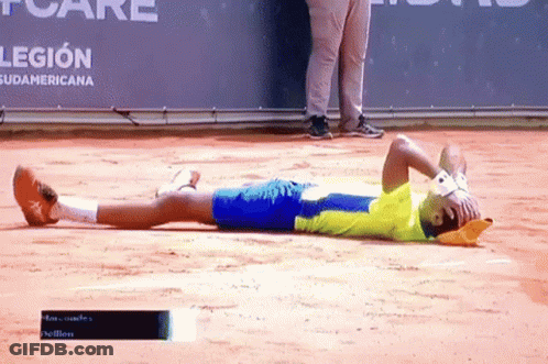A Man Laying On The Ground With His Head In His Hands In Front Of A Banner That Says Legion GIF