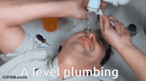 A Man Laying Under A Sink With The Words " A Level Plumbing " On The Bottom GIF