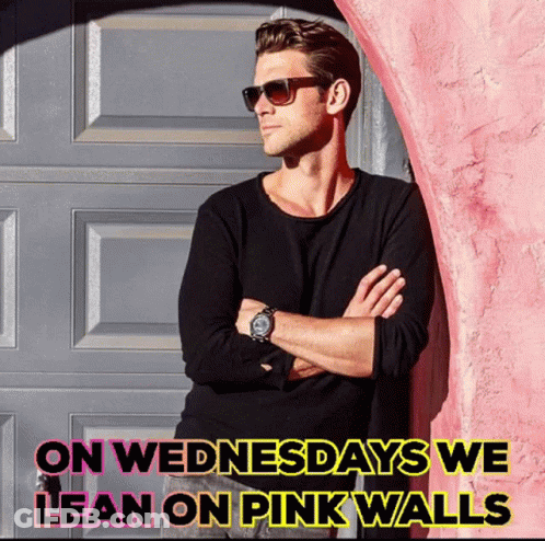 A Man Leaning Against A Pink Wall With The Words " On Wednesdays We Lean On Pink Walls " Above Him GIF