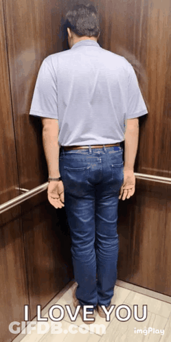 A Man Leaning Against A Wall In An Elevator With The Words I Love You On The Bottom GIF