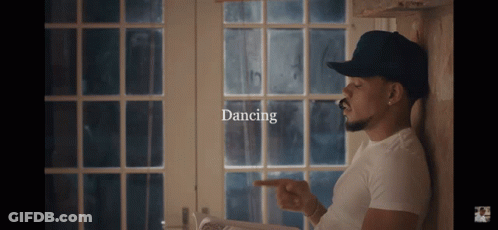 A Man Leaning Against A Wall With The Word Dancing On The Bottom GIF