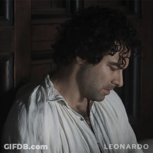 A Man Leaning Against A Wall With The Word Leonardo On The Bottom Right GIF