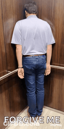 A Man Leaning Against A Wall With The Words Forgive Me Written Below Him GIF