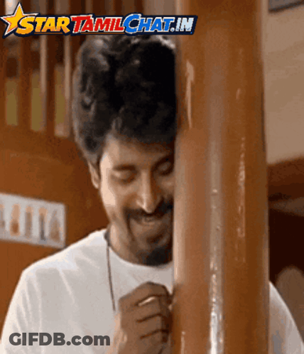 A Man Leaning Against A Wooden Pole With The Words Star Tamilchat.in Written Above Him GIF