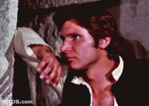 A Man Leaning On A Wall With His Hand On His Chin GIF