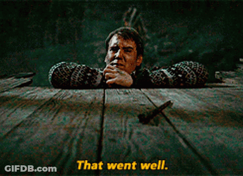 A Man Leaning Over A Wooden Table With The Words That Went Well Written Below Him GIF