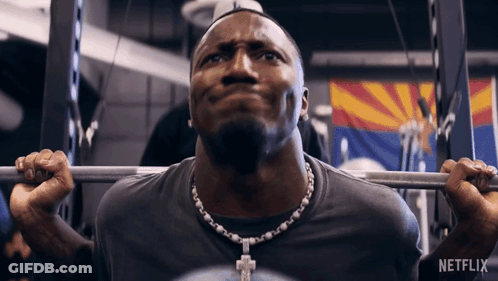 A Man Lifting A Barbell In A Gym With Netflix Written On The Bottom GIF