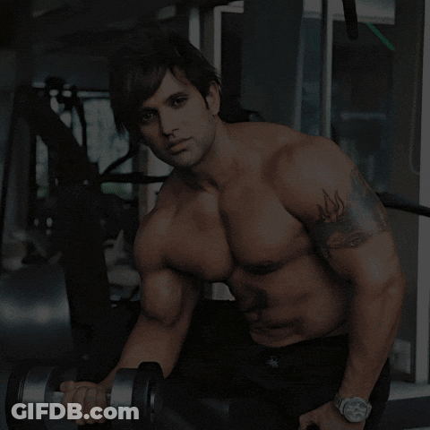 A Man Lifting A Dumbbell In A Gym With The Words Where Sweat Turns Into Strength GIF