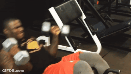 A Man Lifting Dumbbells In A Gym With The Words Mo Usman Is Here To Below Him GIF