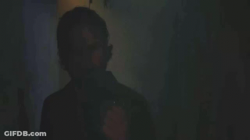 A Man Lighting A Cigarette With The Words " You Still " In The Background GIF