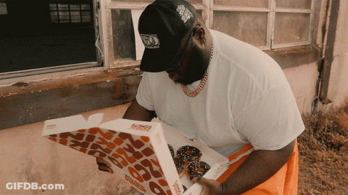 A Man Looking At A Dunkin Donuts Box GIF