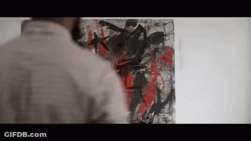 A Man Looking At A Painting On A Wall GIF