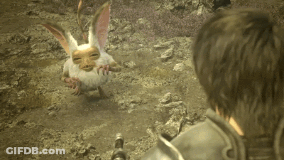 A Man Looking At A Small Creature With A Face GIF