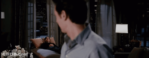 A Man Looking At A Woman Laying On A Couch With The Words " That Was Quite A Performance Today " GIF