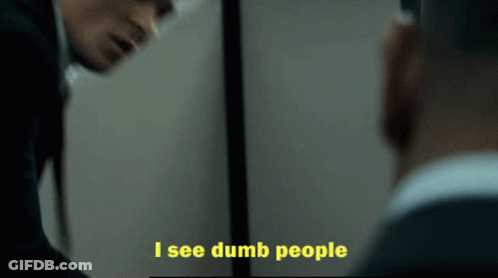 A Man Looking At Himself In A Mirror With The Words I See Dumb People Below Him GIF