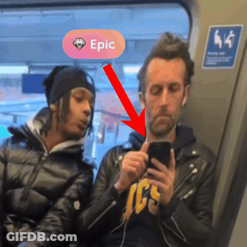 A Man Looking At His Phone Next To A Woman With A Pink Circle That Says Epic GIF