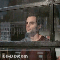 A Man Looking Out A Window With A Reflection Of A Building GIF