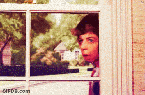 A Man Looking Out A Window With The Letters Ap Visible GIF
