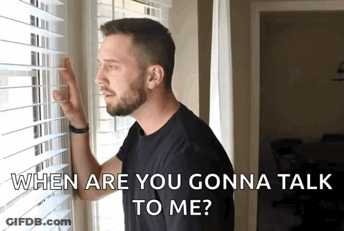 A Man Looking Out A Window With The Words " When Are You Gonna Talk To Me " Above Him GIF