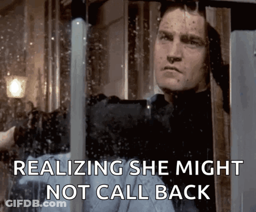 A Man Looking Out Of A Window With The Words Realizing She Might Not Call Back GIF
