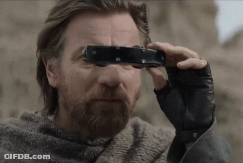 A Man Looking Through A Pair Of Binoculars With A Beard GIF