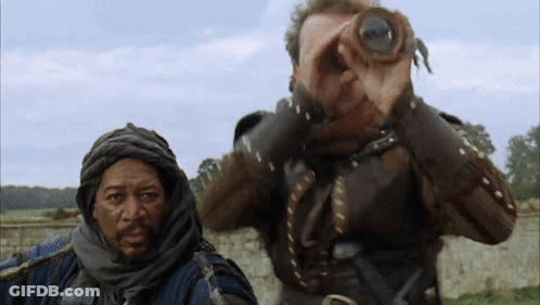 A Man Looking Through Binoculars With Another Man Behind Him GIF