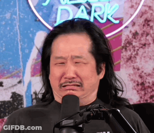 A Man Making A Funny Face In Front Of A Sign That Says Dark GIF
