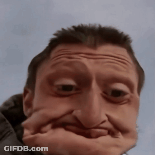 A Man Making A Funny Face With His Hand GIF