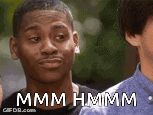 A Man Making A Funny Face With The Words Mmmm Hmmm Written Below Him GIF