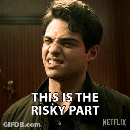 A Man Making A Funny Face With The Words " This Is The Risky Part " Behind Him GIF