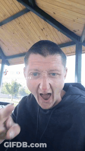 A Man Making A Funny Face With Tik Tok Written On The Bottom Right GIF
