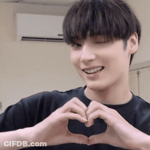 A Man Making A Heart Shape With His Hands GIF